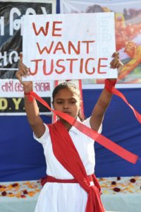 A young student holds a placard during 'Nirbhaya Day' to mark the anniversary of the brutal rape case of a 23-year-old physiotherapy student on a bus in New Delhi in 2012, on December 16, 2019.