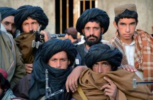 In this photograph taken on November 3, 2015, Afghan Taliban fighters look on as they listen to Mullah Mohammad Rasool Akhund (unseen), the newly appointed leader of a breakaway faction of the Taliban, at Bakwah in the western province of Farah. (AFP)