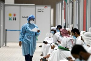 People sit as they wait their turn for vaccine trials in Abu Dhabi, UAE, October 6, 2020. (Reuters)