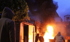 Demonstrators set fire near the government Serail building, during a protest in Tripoli. (Reuters)