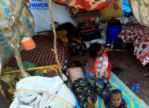 Ethiopians who fled the ongoing fighting in Tigray region, sit and lay in their makeshift shelter in the Hamdayet village, in eastern Kassala state, Sudan. (Reuters)