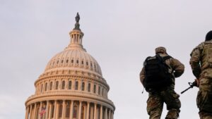 FILE PHOTO: National Guard members walk at the Capitol, in Washington, U.S., January 15, 2021. (Reuters)