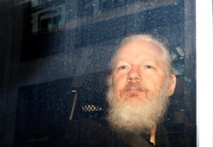 WikiLeaks founder Julian Assange is seen in a police van, after he was arrested by British police, in London. (Reuters)