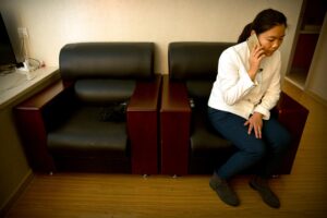 Xu Yan, the wife of Chinese lawyer Yu Wensheng, talks on her cellphone in their apartment on the outskirts of Beijing on Friday, January 19, 2018, after her husband was taken into custody. (AP)