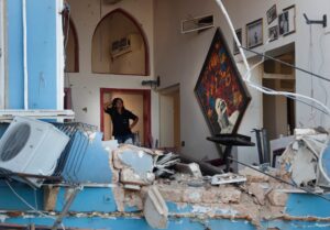 A woman stands inside a damaged restaurant a day after an explosion hit the seaport of Beirut, Lebanon, Wednesday, Aug. 5, 2020. (AP)