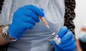 A health worker fills a syringe with a dose of the Oxford/AstraZeneca COVID-19 vaccine. (Reuters)