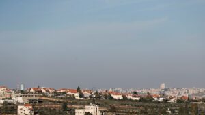 A view shows Palestinian houses as an Israeli settlement is seen in the background near Ramallah in the Israeli-occupied West Bank. (Reuters)