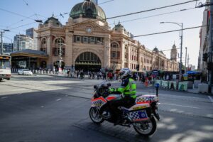 A policeman patrols on a motorcycle in Melbourne on February 12, 2021, after authorities ordered a five-day state-wide lockdown starting at midnight local time to stamp out a new coronavirus outbreak. (AFP)