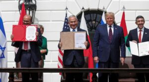 Bahrain’s Foreign Minister Abdullatif Al Zayani, Israel's Prime Minister Benjamin Netanyahu and United Arab Emirates (UAE) Foreign Minister Abdullah bin Zayed display their copies of signed agreements while U.S. President Donald Trump looks on as they participate in the signing ceremony of the Abraham Accords