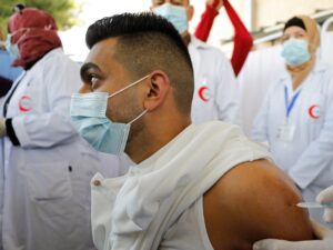 Palestinian health workers are vaccinated against COVID-19 in Bethlehem. (Reuters)