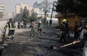 Afghan firefighters remove the remains of a burnt car at the site of a bomb blast in Kabul, Afghanistan January 10, 2021. (Reuters)