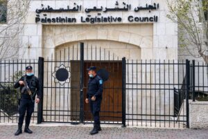 Members of the Palestinian security forces stand guard outside the Legislative Council building in the occupied-West Bank town of Ramallah, on January 16, 202. (Ahmad Gharabli/AFP)