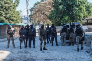 Several police officers from different specialized groups provide perimeter protection by the Croix-des-Bouquets prison from where many prisoners escaped and where several people were killed, in Croix-des-Bouquets, suburb of the Haitian capital, on February 25, 2021 AFP