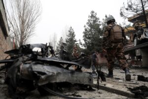 Security personnel inspect the site of a bomb attack in Kabul, Afghanistan, Saturday, Feb. 20, 2021.