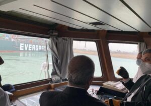 Officials monitor a container ship which was hit by strong wind and ran aground in Suez Canal, Egypt March 24, 2021. (Reuters)