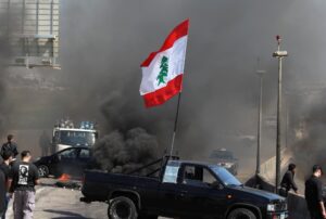 A vehicle blocks a road during a protest against the fall in Lebanese pound currency and mounting economic hardships in Khaldeh, Lebanon March 8, 2021. (Reuters)