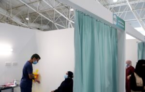 A Saudi woman waits to get a dose of a coronavirus disease (COVID-19) vaccine, in Riyadh. (Reuters)