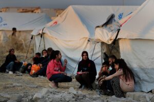 Syrians wait to receive tents and aid supplies at the Bardarash refugee camp, north of Mosul, Iraq on Oct. 17, 2019. (AP)