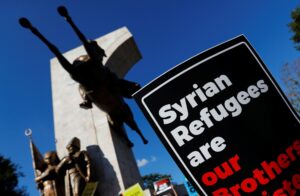 Demonstrators hold placards in support of Syrian refugees during a protest against Turkish government's refugee policies in Istanbul, Turkey, July 27, 2019. (Reuters)