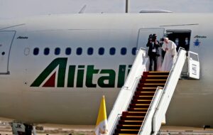 Pope Francis bows in farewell to his hosts before boarding his Alitalia Airbus A330 aircraft as he departs from the Iraqi capital's Baghdad International Airport on March 8, 2021. (AFP)