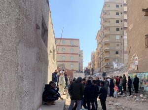 People inspect the area where a building was collapsed in Gesr al-Suez, Cairo. (Reuters)