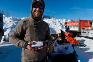 In this March 7, 2021, file photo, Larry Daugherty, a musher from Eagle River, will carry empty packages of COVID-19 vaccine with him on the trail this year as mushers began the Iditarod Sled Dog Race from the start area at Deshka Landing in Willow, Alaska. (AP)