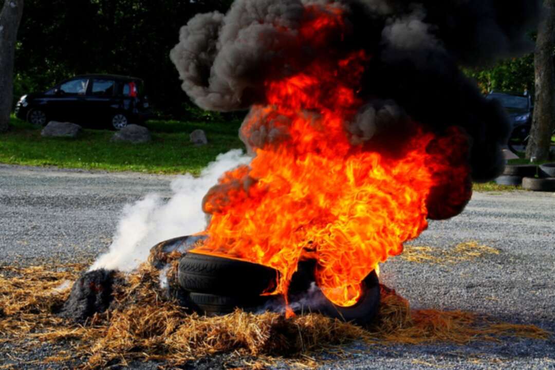 Lebanese demonstrators burn tires and block roads in protest at economic crisis