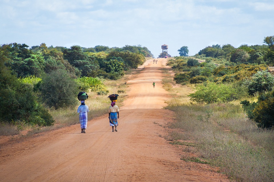 African women walking along road-Sand road to Mapai/Pixabay